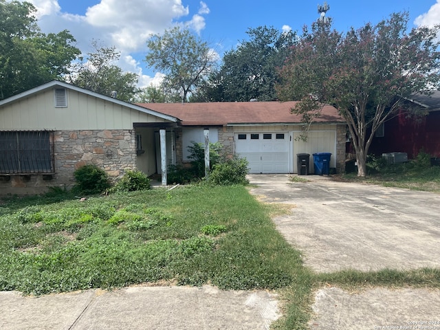 single story home with a front lawn and a garage