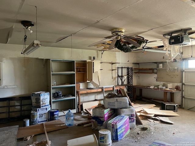 garage with a garage door opener and ceiling fan