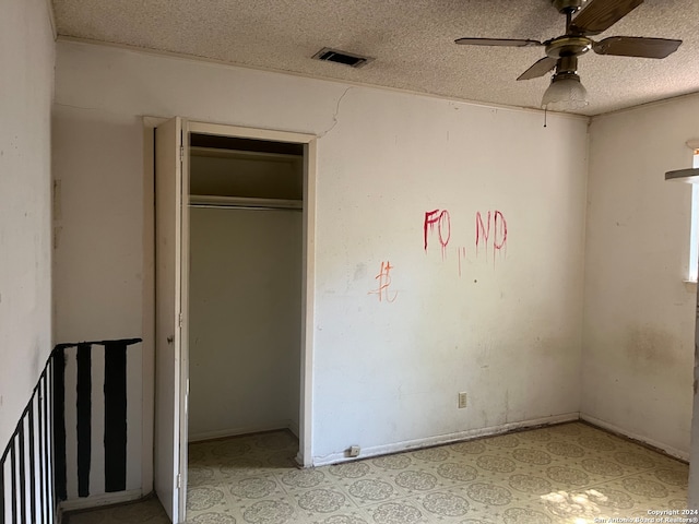 unfurnished bedroom featuring a closet, ceiling fan, and a textured ceiling