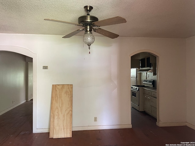 unfurnished room with a textured ceiling, dark hardwood / wood-style floors, and ceiling fan