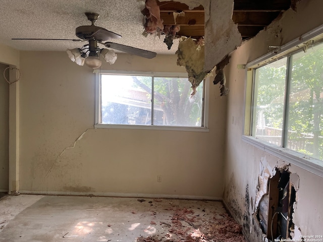 spare room featuring a textured ceiling and ceiling fan