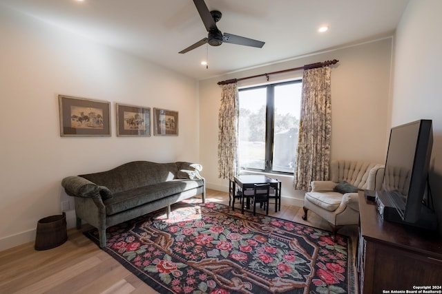 sitting room with light hardwood / wood-style flooring and ceiling fan