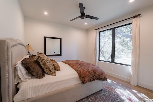 bedroom with ceiling fan and light hardwood / wood-style floors