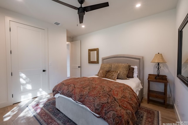 bedroom with ceiling fan and light wood-type flooring