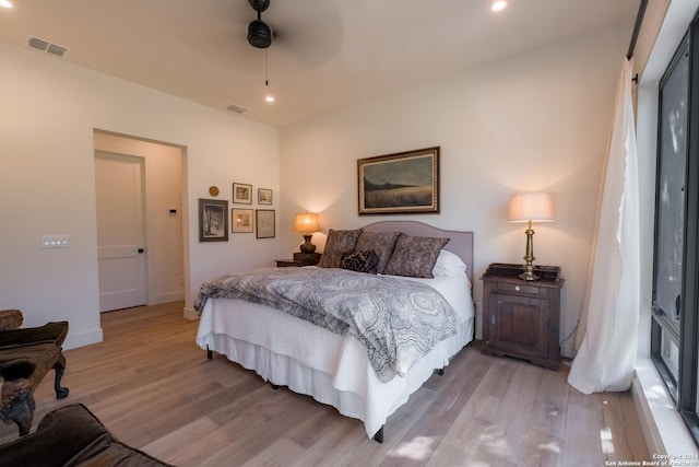 bedroom featuring ceiling fan, a closet, and light hardwood / wood-style flooring