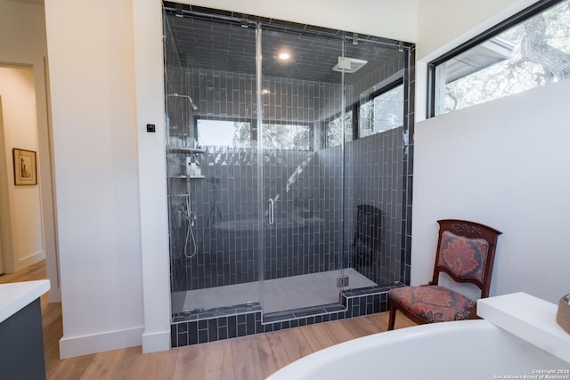 bathroom featuring hardwood / wood-style floors and an enclosed shower