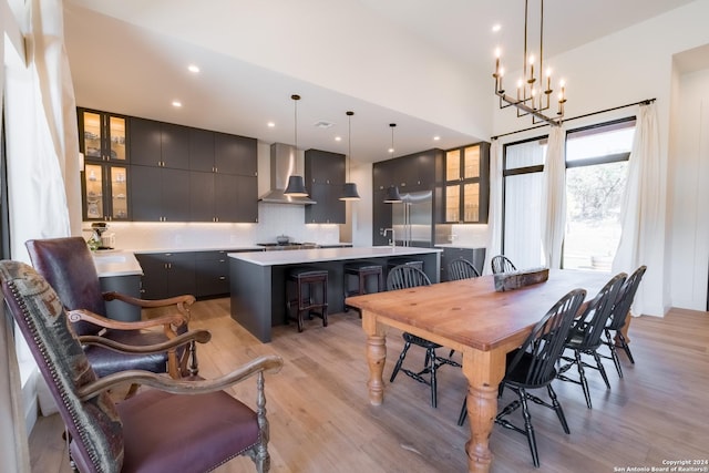 dining room with light hardwood / wood-style floors and an inviting chandelier