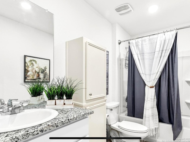 full bathroom with shower / tub combo with curtain, vanity, and toilet