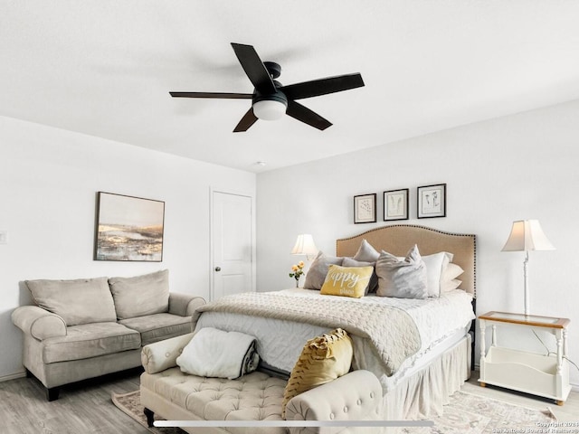 bedroom with ceiling fan and light hardwood / wood-style flooring