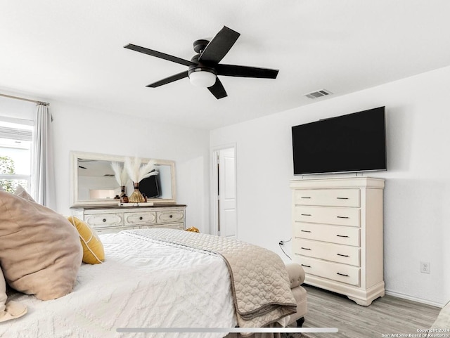 bedroom with light hardwood / wood-style flooring and ceiling fan