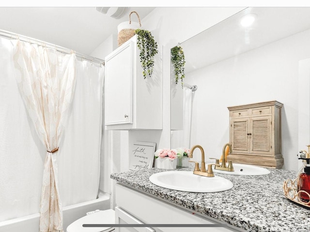 full bathroom featuring shower / bath combo, vanity, and toilet