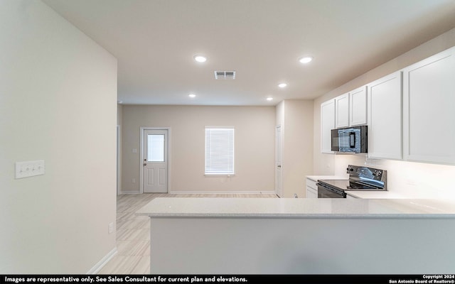 kitchen with white cabinets, kitchen peninsula, and black appliances