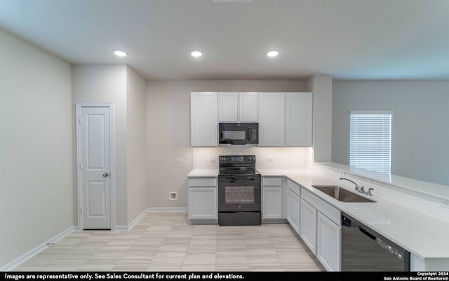 kitchen with light stone counters, white cabinets, sink, kitchen peninsula, and black appliances