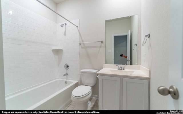 full bathroom featuring vanity, tiled shower / bath combo, and toilet