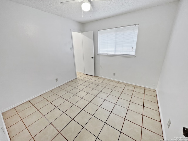 unfurnished room featuring ceiling fan and a textured ceiling