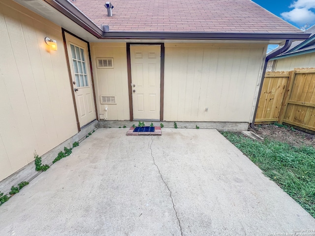 view of exterior entry featuring a patio area