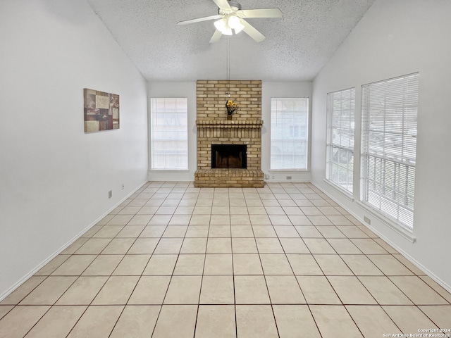 unfurnished living room featuring vaulted ceiling, ceiling fan, plenty of natural light, and a textured ceiling