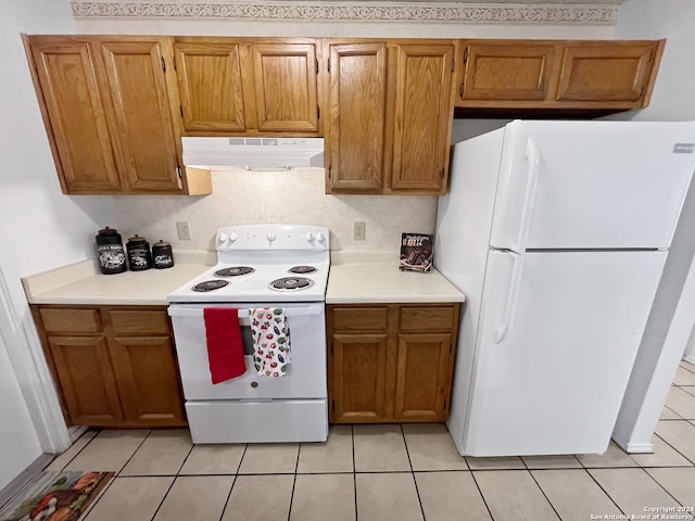 kitchen with white appliances and light tile patterned floors