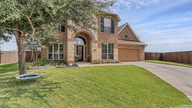 view of front of house featuring a garage and a front lawn