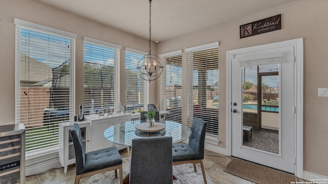 dining space featuring a notable chandelier, a wealth of natural light, and wine cooler