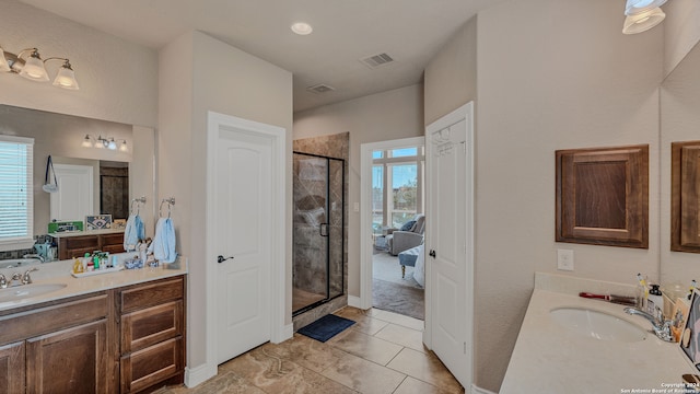 bathroom with tile patterned flooring, vanity, and an enclosed shower