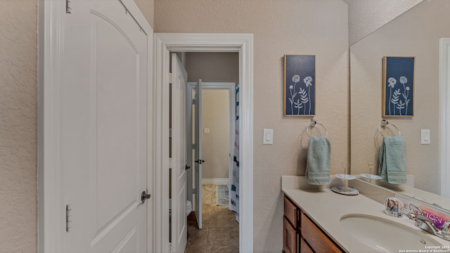 bathroom featuring tile patterned flooring and vanity