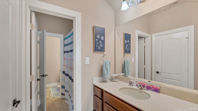 bathroom with tile patterned flooring, vanity, and toilet