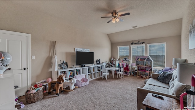 carpeted living room featuring vaulted ceiling, ceiling fan, and a textured ceiling