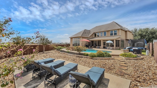 exterior space with a fenced in pool and a trampoline