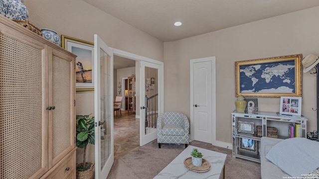 living area featuring carpet flooring and french doors