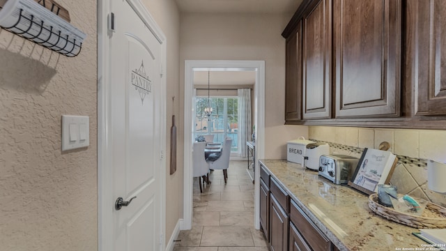 kitchen with dark brown cabinets and light stone counters