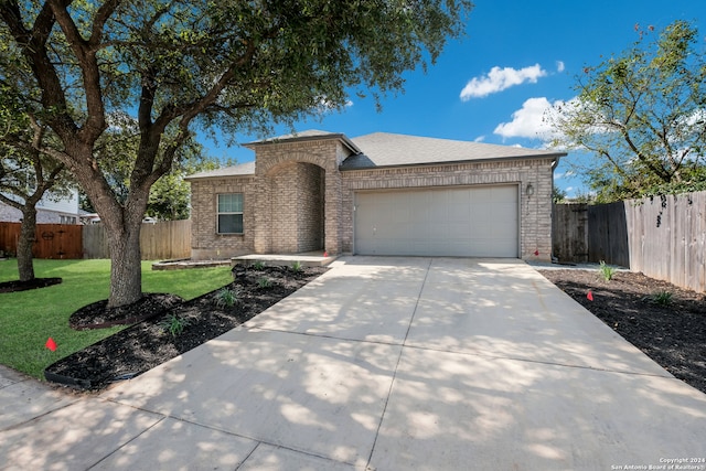 view of front of house featuring a front yard and a garage