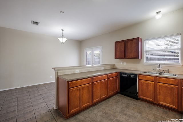 kitchen featuring dark tile patterned floors, dishwasher, sink, kitchen peninsula, and hanging light fixtures