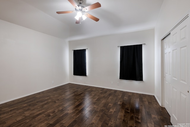 unfurnished bedroom with ceiling fan, a closet, and dark hardwood / wood-style floors