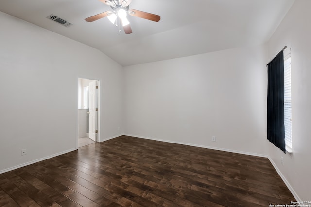 spare room featuring ceiling fan, dark hardwood / wood-style floors, and vaulted ceiling