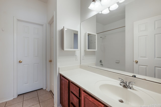 bathroom with tub / shower combination, vanity, and tile patterned floors