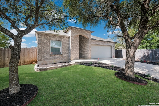 view of front of house with a front lawn and a garage