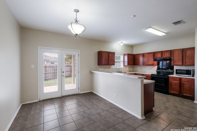 kitchen featuring dark tile patterned flooring, black electric range, sink, kitchen peninsula, and hanging light fixtures