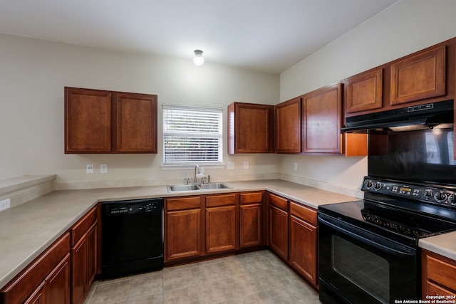 kitchen featuring black appliances, light tile patterned floors, and sink