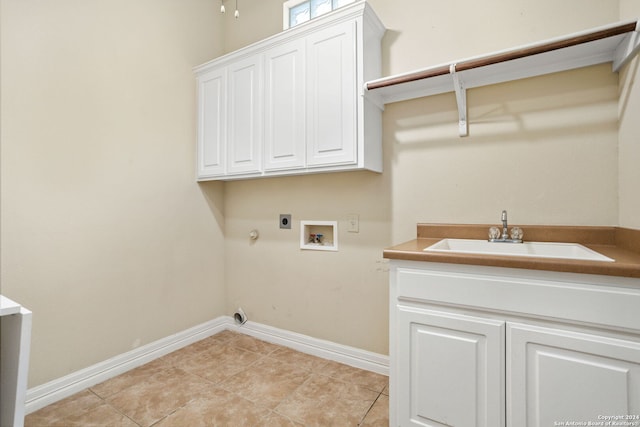 laundry room featuring washer hookup, sink, hookup for an electric dryer, gas dryer hookup, and cabinets