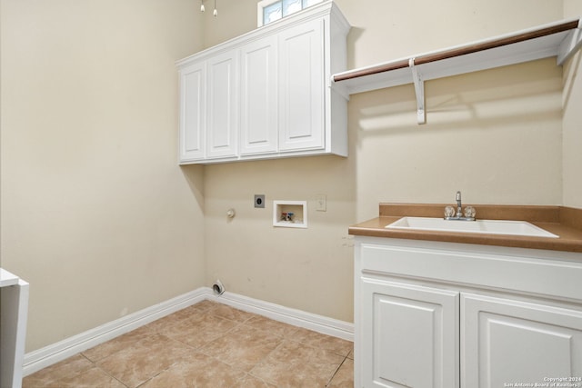 washroom with hookup for a washing machine, electric dryer hookup, a sink, gas dryer hookup, and cabinet space