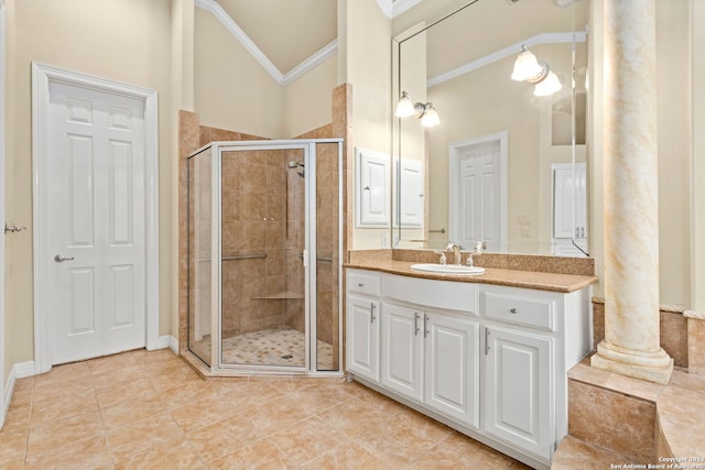 bathroom with walk in shower, vanity, ornate columns, and ornamental molding