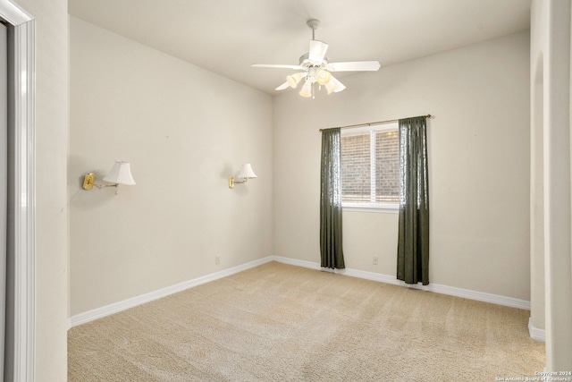 unfurnished room with ceiling fan and light colored carpet