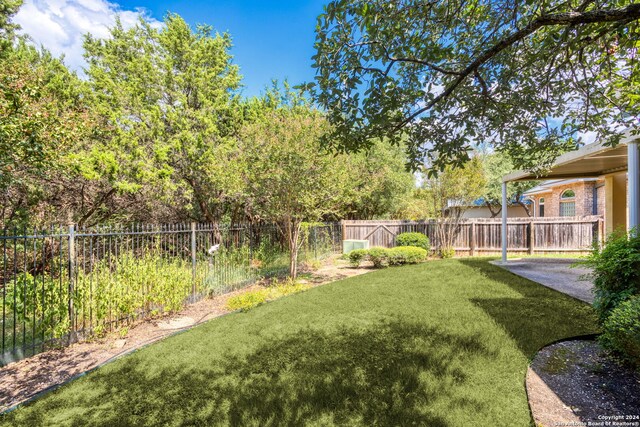 view of yard featuring a patio area and a fenced backyard