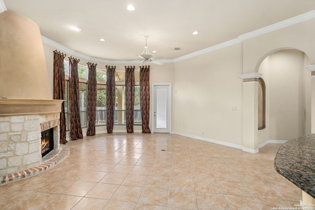 tiled living room featuring ceiling fan and crown molding