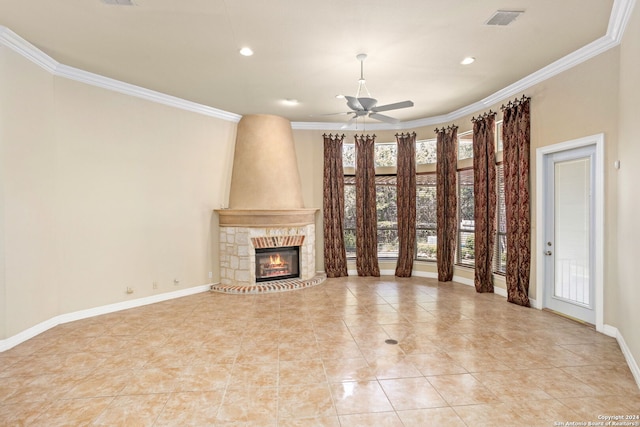 unfurnished living room with ceiling fan, a stone fireplace, light tile patterned flooring, and ornamental molding