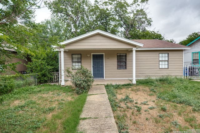 view of front of home featuring a front yard and covered porch