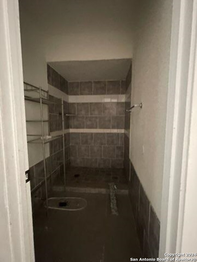 bathroom with tiled shower