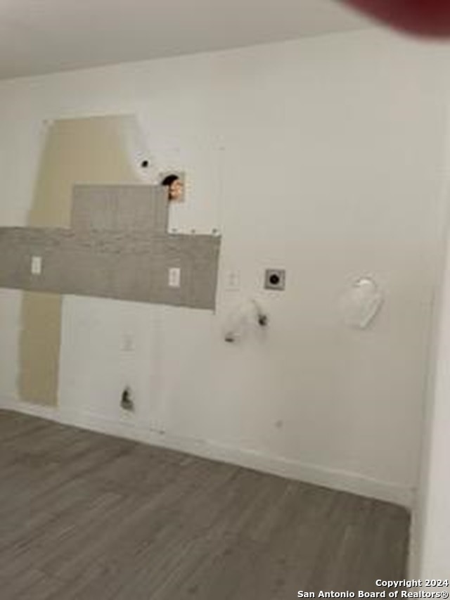 washroom with dark hardwood / wood-style flooring and hookup for an electric dryer