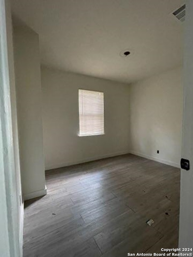 unfurnished room with hardwood / wood-style floors